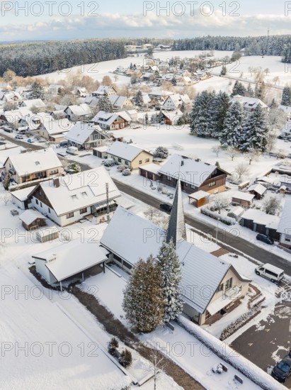 Snow-covered roofs and church in a wintry village, Oberreichenbach, Black Forest, Calw district,
