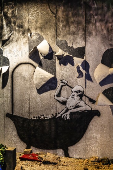Banksy - Bad in Truemmern, painting on a destroyed house wall in Kiev, Ukraine, exhibition The