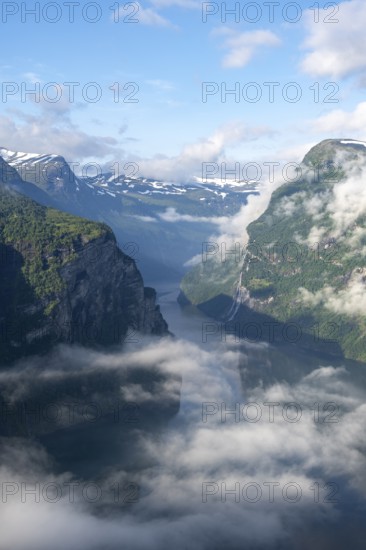 View over the Geirangerfjord, atmospheric clouds over the fjord in the morning light, Ørnesvingen