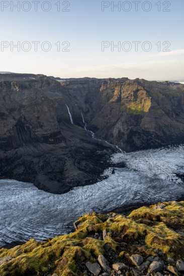 Waterfalls on a cliff, Impressive landscape with mountains and glaciers in the evening light,