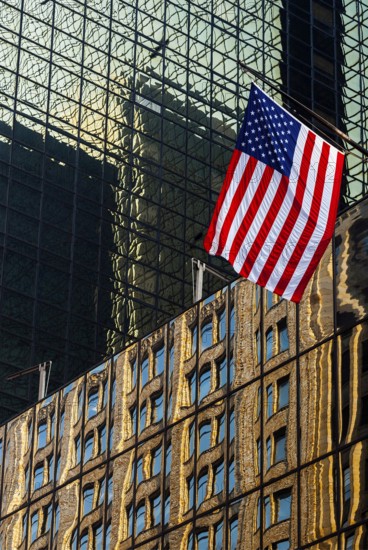 Reflections in glass facades, us national flag, stars stripes, Manhattan, New York City, USA