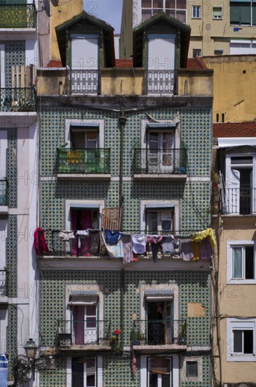 Residential building, house facade, narrow, azulejos, tiles, tile decoration, laundry for drying,