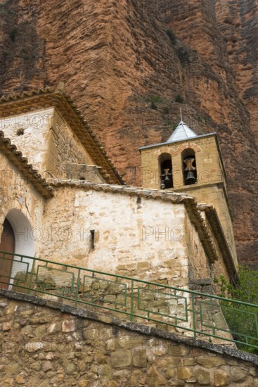 Old church with bell tower, embedded in a mountainous landscape with stone walls, Las Peñas de