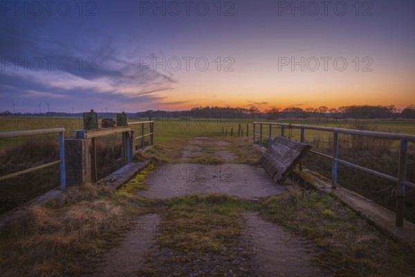 View of a sluice and a bridge with a pasture behind it at sunset, Kirchlinteln, Verden, Aller Leine