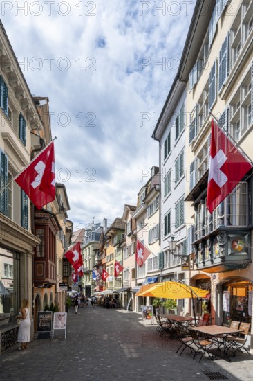 Augustinergasse with Swiss flags, alley with historic houses, Old Town, Zurich, Switzerland