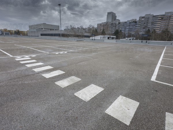 Symbolic image economic crisis, dark clouds in the sky, empty parking deck at
