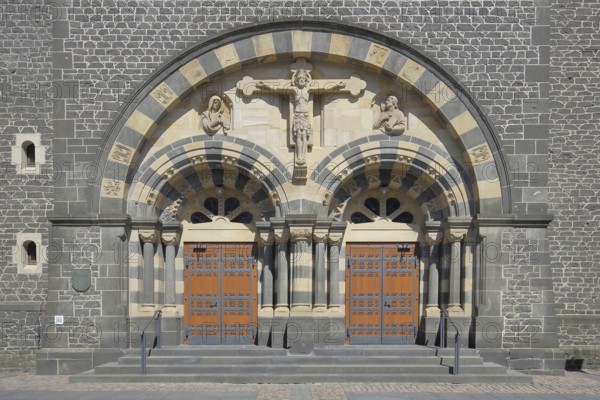 Portal with crucifix of the Herz-Jesu-Kirche built in 1912, church door with fittings, church
