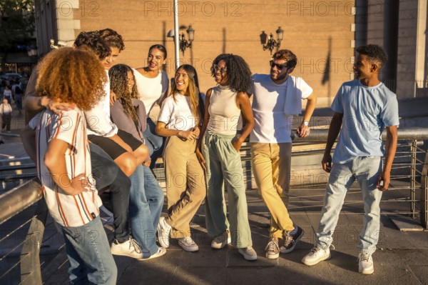 Relaxed group of friends talking standing in the city during sunset