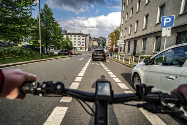 Cycling in the city, city centre road, car blocking cycle lane traffic in both directions, cyclist