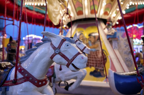 Horses on children's carousel, rides, neon lights, Cannstatter Wasen, funfair, spring festival,