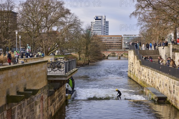 Leine wave, river Leine, footpath, bare wintry trees, lanterns, general architecture, high-rise