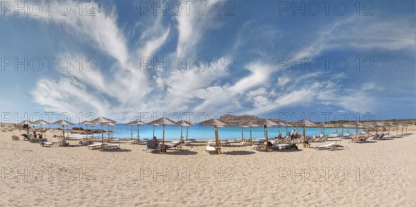 Diakoftis extensive sandy beach with parasols and sun loungers under a clear blue sky, Diakoftis