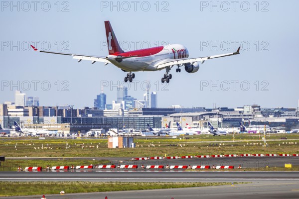 Fraport Airport in Frankfurt am Main. Aircraft landing against the backdrop of the banking district
