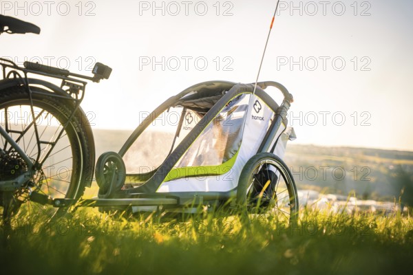 Side view of a bicycle trailer in a meadow with a wide view, e-bike, forest bike, Calw, district of