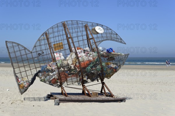 Wire sculpture as a rubbish bin on the sandy beach of Norderney, North Sea, East Frisian Islands,