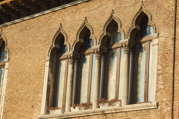 Windows of an old house on 'Campo santa margherita' town square in Venice on a sunny day in winter,