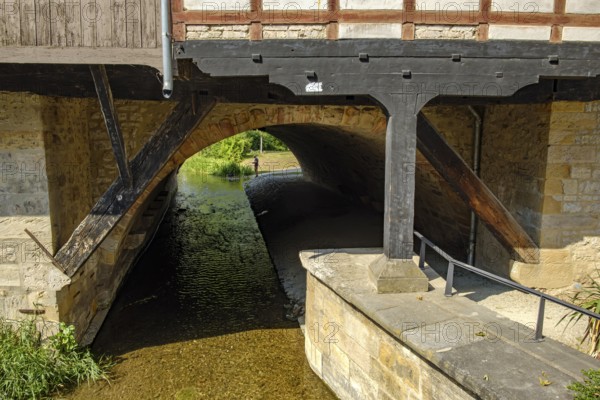 View from the Rathausbrücke bridge onto an arch of the Krämerbrücke bridge with the Gera river