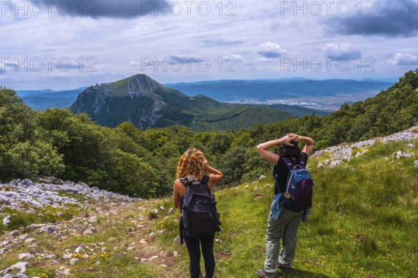 Mount Aizkorri 1523 meters, the highest in Guipuzcoa. Basque Country. Two friends on the trail to