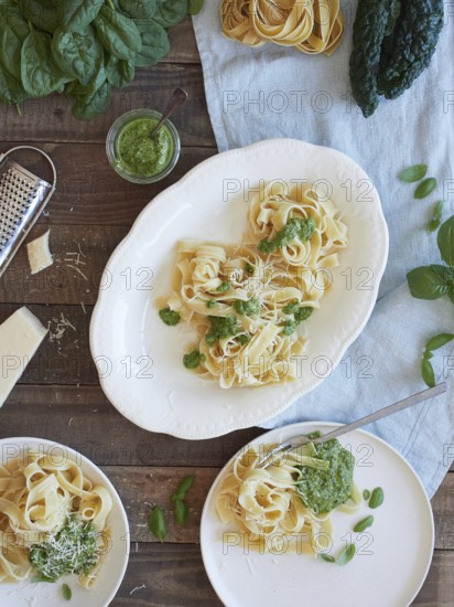 Green Tagliatelle pasta with spinach and kale pesto beside parmesan cheese. Traditional Italian
