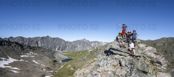 Group of mountaineers on the summit of the Göseleswand, mountain landscape with rocky mountain