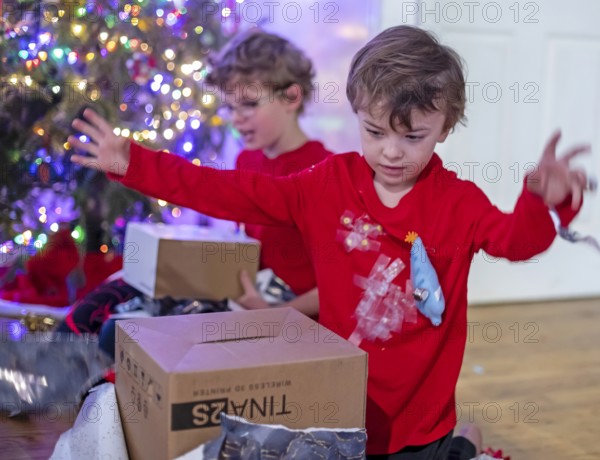 Denver, Colorado - Hendrix Hjermstad, 6, (right) and his brother Adam Hjermstad Jr., 10, open