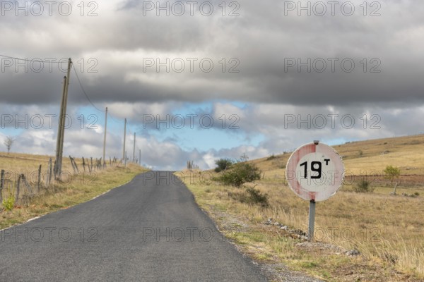Desolate road in the countryside on a sunny summer day. Cevennes, France