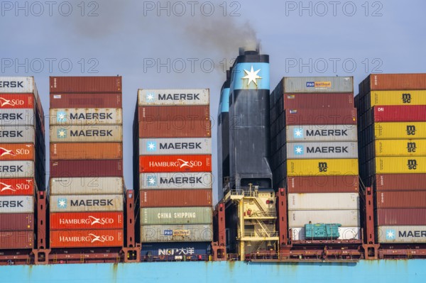 Container freighter Madison Maersk smoking chimneys of the ship's diesel engines, Maasvlakte 2,