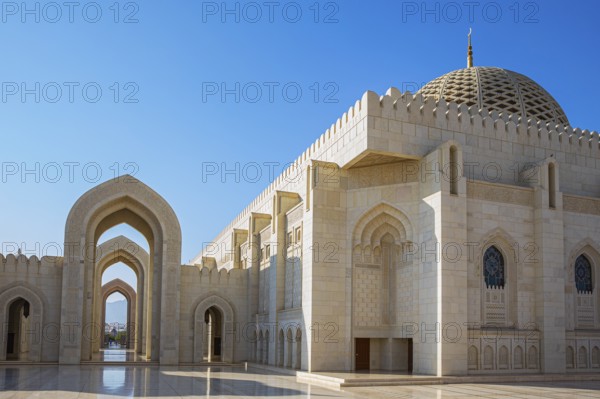 Arched gates and large hall with dome of the Sultan Qaboos Mosque, Muscat, Arabian Peninsula,