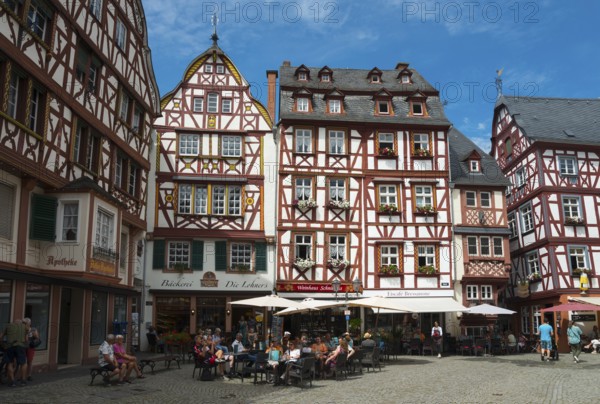 Lively square in the old town centre with half-timbered houses and cafés in sunny weather, market