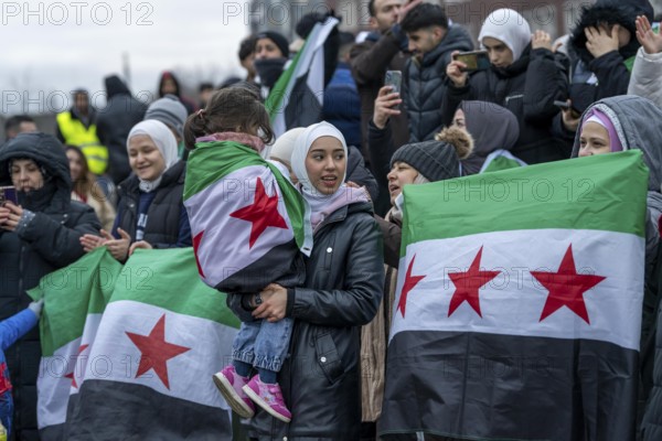Syrian woman celebrate the end of the Assad regime after the change of power in Syria at a rally on