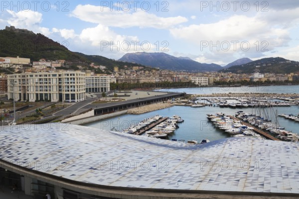 High angle view of roof of Salerno cruise port terminal building by Zaha Hadid and marina with