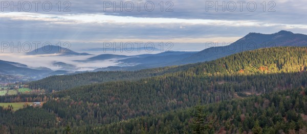 View from the Hindenburgkanzel over endless forests in autumn with valley fog, on the right the