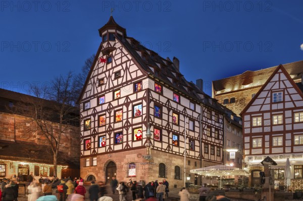 Historic Pilkatushaus with an Advent calendar on 18 December 2024 at dusk, behind the Imperial