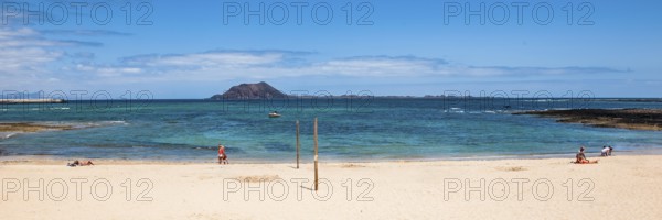 Panoramic photo of Corralejo beach in the background uninhabited island Islote de Lobos in the East