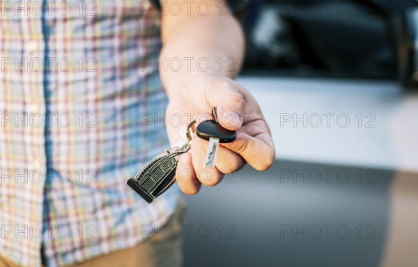 Driver's hands showing the car keys, Close-up of male driver hands showing the keys, Vehicle rental