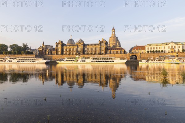 Silhouette of the Old Town with reflection in the Elbe in the morning, steamboats on the