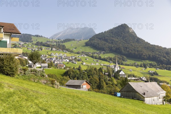 View of Amden with church and Chapf, in the background the Churfirsten mountain range with the