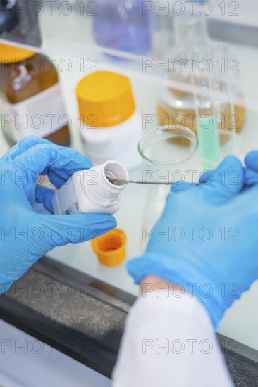 A spoon is inserted into a small bottle of chemicals, Nagold Youth Research Centre, Black Forest