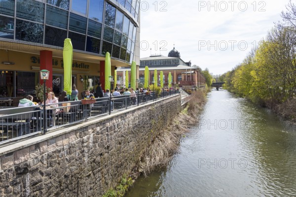 Outdoor area of a restaurant on the banks of the Chemnitz at Seeberplatz, in the background the
