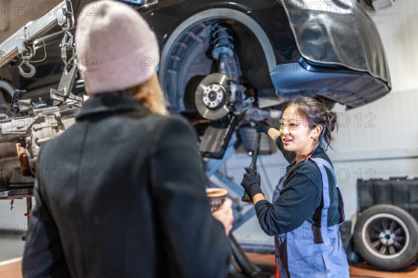 Skilled mechanic discussing vehicle maintenance with a customer, highlighting professionalism and