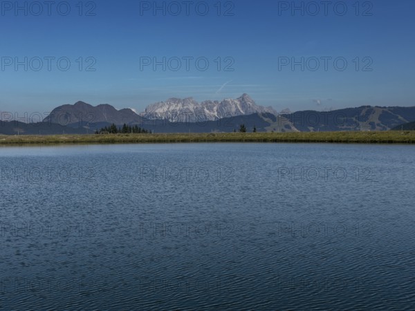 Tyrolean mountains near Saalbach-Hinterglemm, view over the Zwölferkogel reservoir, behind