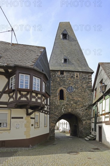 Historic clock tower and half-timbered house with oriel, landmark, town gate, town tower,