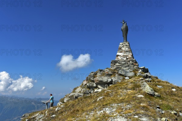 On the summit of Mont Noble, figure of the Virgin Mary with child and hiker at the panorama panel,