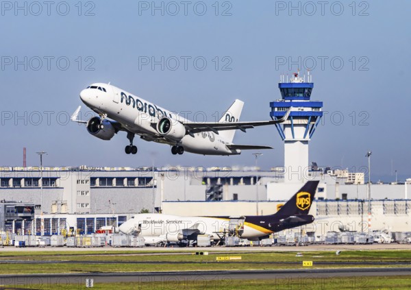 Cologne Bonn Airport with tower. Aircraft taking off. Aircraft registration number ES-MBA, Marabou