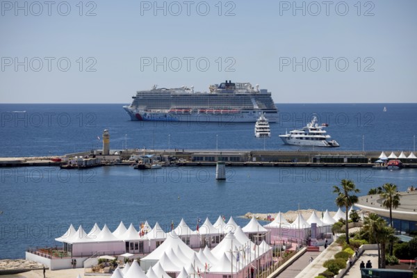 Cannes, France - 23 May 2024: A cruise ship anchors in front of the beach on the Promenade de la
