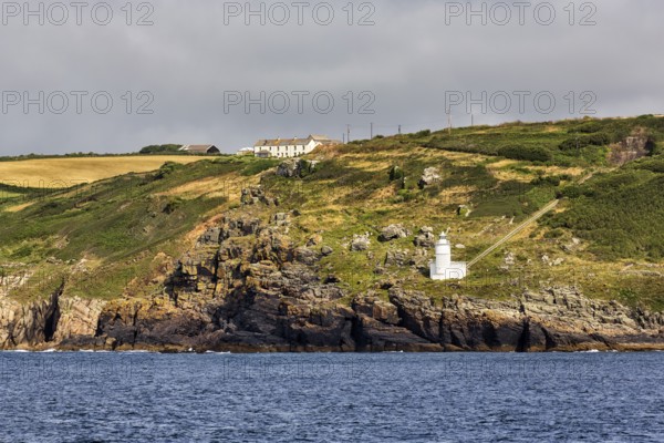 Tater-du lighthouse on rocky coast, Penzance, Cornwall, England, United Kingdom