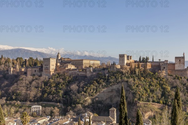 Alhambra on the Sabikah hill, Moorish city castle, Nasrid palaces, behind the snow-covered Sierra