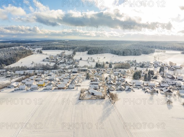 Snowy landscape with a village surrounded by fields and forests, Oberreichenbach, Black Forest,