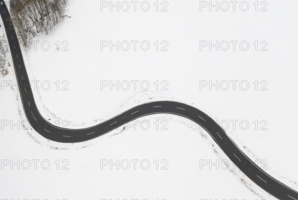 Aerial view of a winding country road in the snow, between Eppendorf and Leubsdorf, Central Saxony,