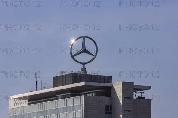 Mercedes star with sun star. Building at the headquarters of Mercedes-Benz Group AG in